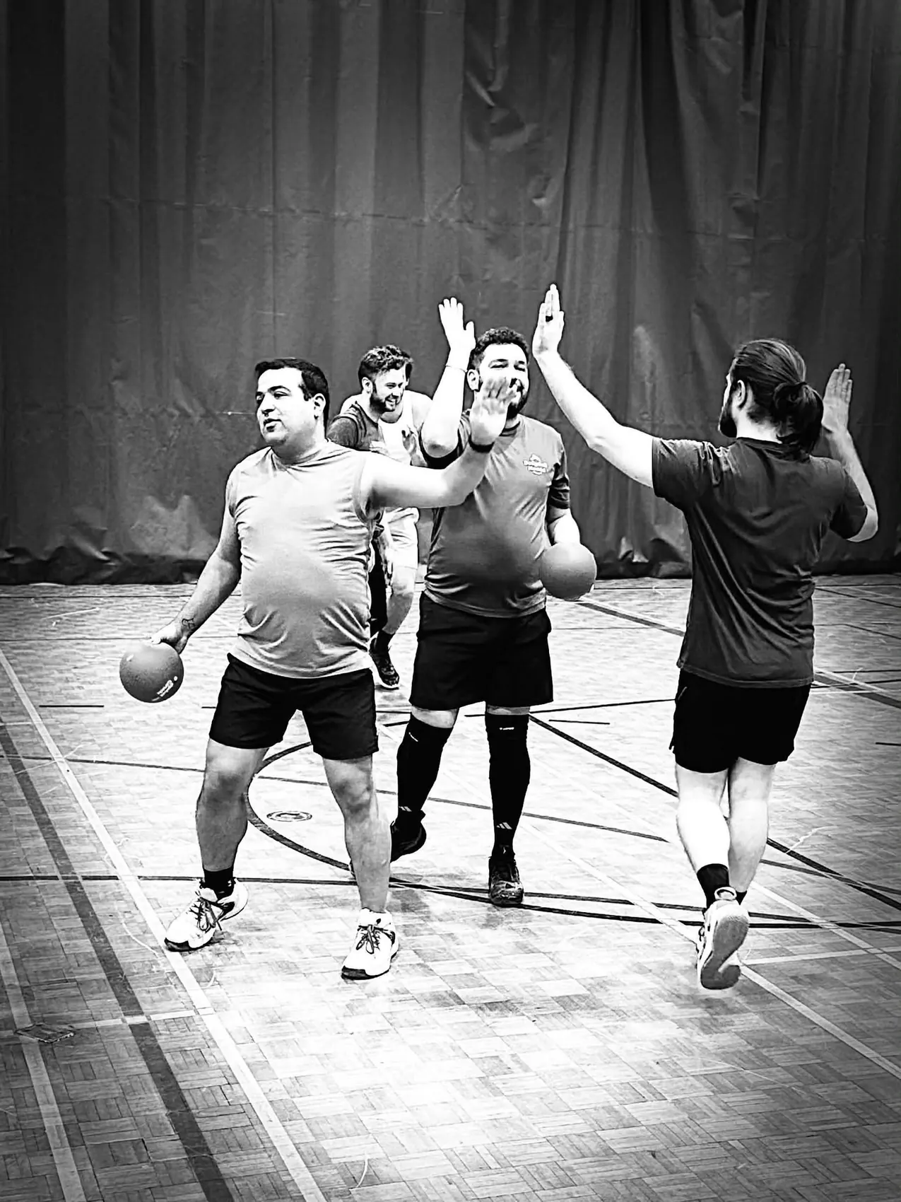 Dodgeball players high-fiving after a play