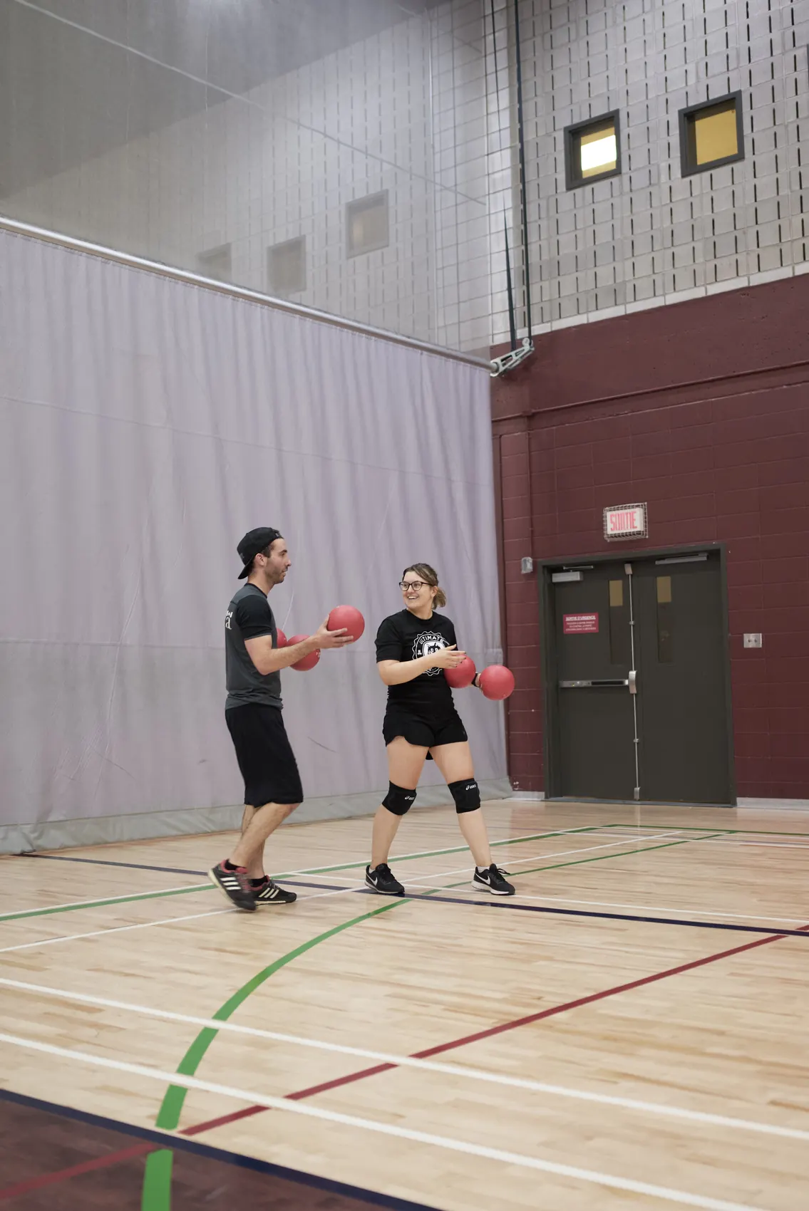Two players with dodgeballs between plays