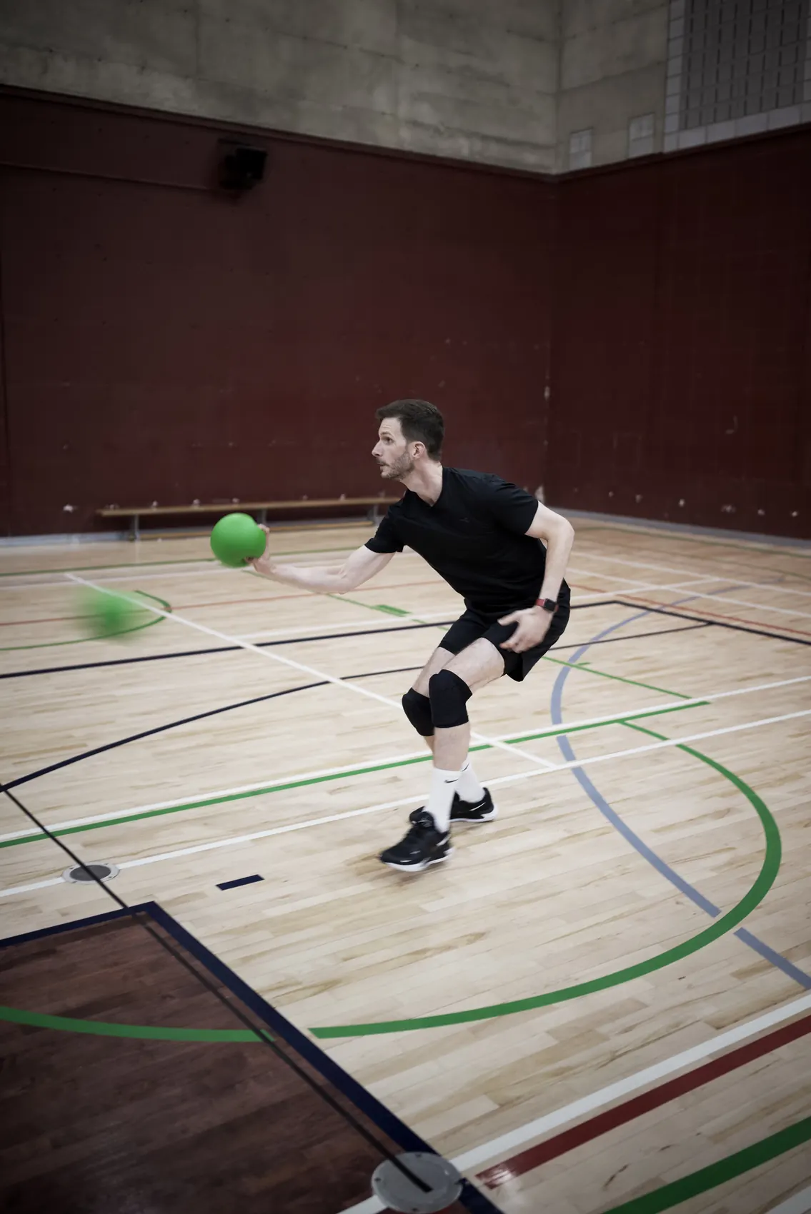 Player running forward with a dodgeball